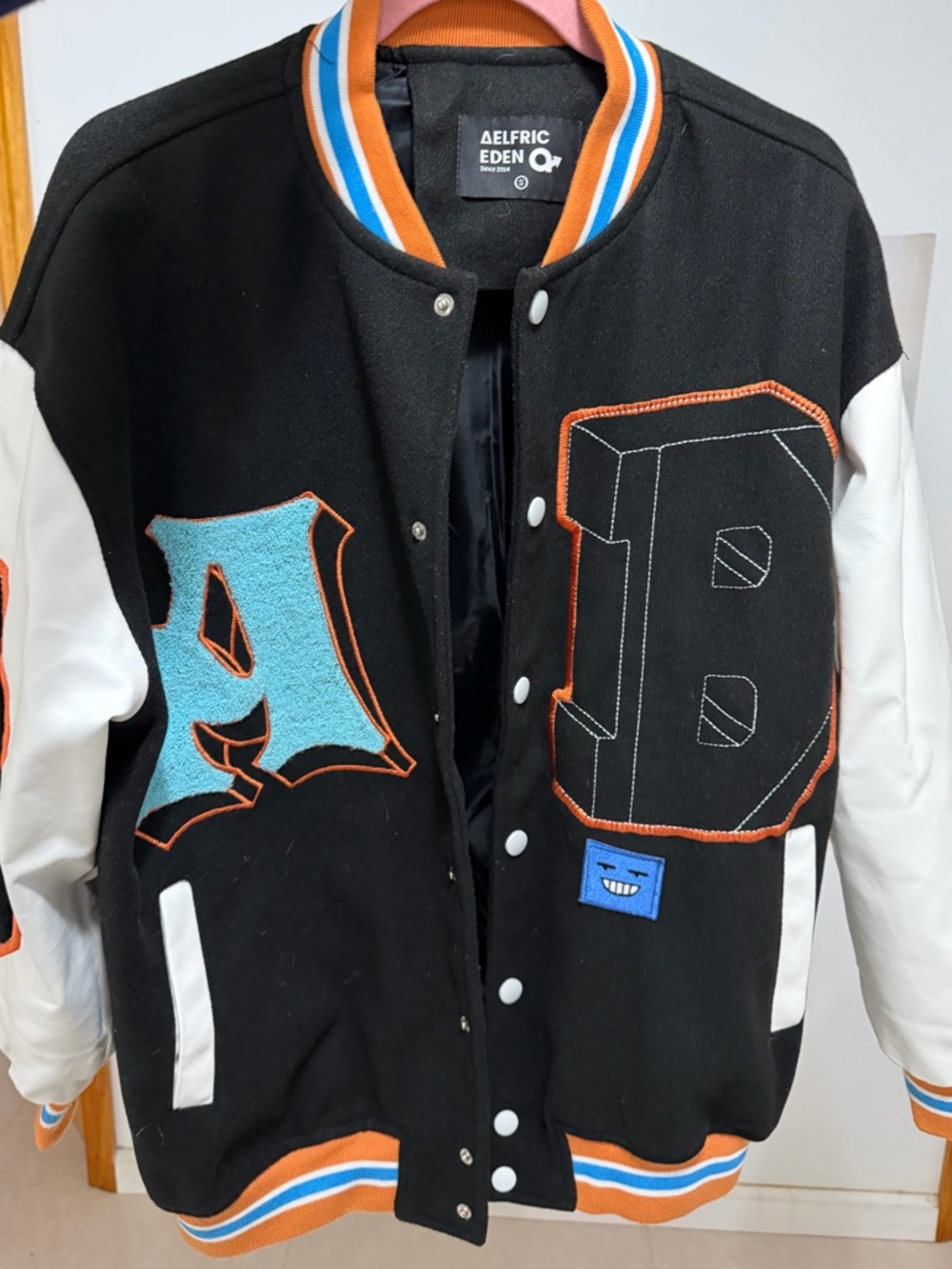 Aelfric Eden Black & White Varsity Jacket with Blue and Orange Accents